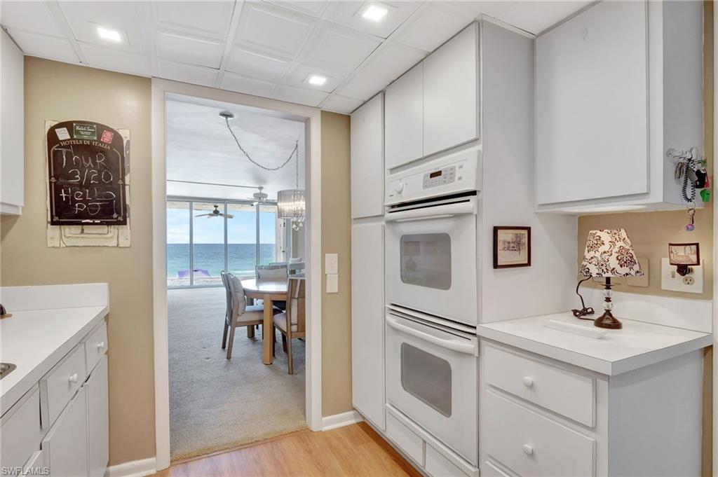 1919 Gulf Shore Boulevard North, Unit 201 Naples, FL 34102 - Photo 13 of 28 a kitchen with cabinets and window