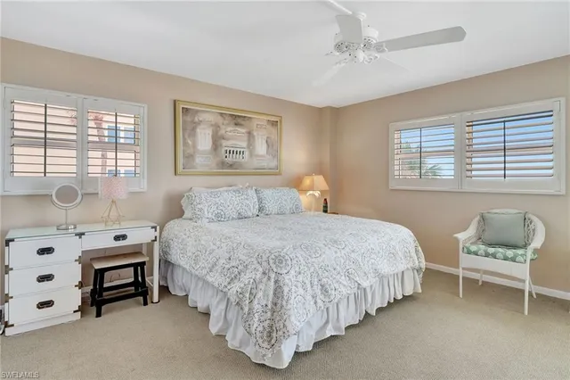 a bedroom with a bed and painting on the wall