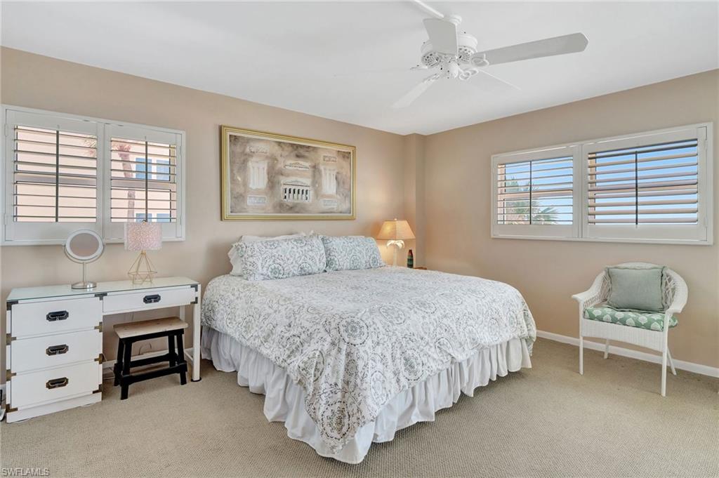 1919 Gulf Shore Boulevard North, Unit 201 Naples, FL 34102 - Photo 14 of 28 a bedroom with a bed and a window