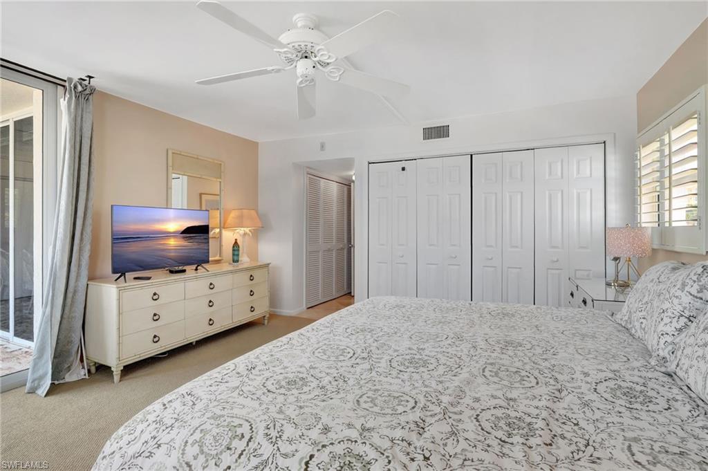 1919 Gulf Shore Boulevard North, Unit 201 Naples, FL 34102 - Photo 16 of 28 a bedroom with a bed and a dresser