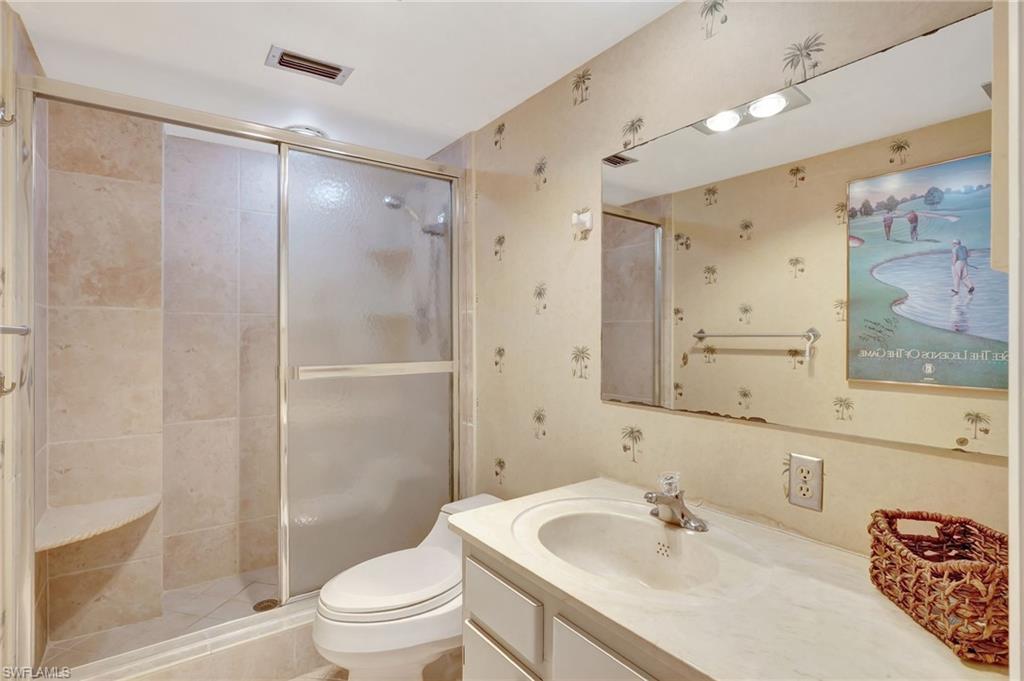 1919 Gulf Shore Boulevard North, Unit 201 Naples, FL 34102 - Photo 17 of 28 a bathroom with a sink toilet and shower