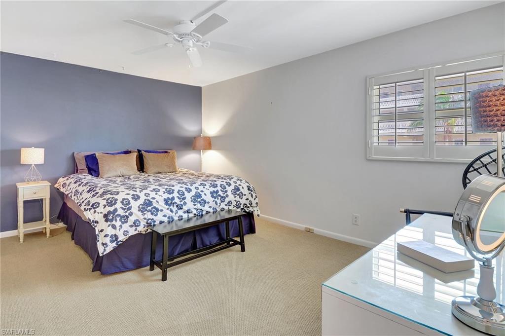 1919 Gulf Shore Boulevard North, Unit 201 Naples, FL 34102 - Photo 18 of 28 a bed sitting in a bedroom next to a window