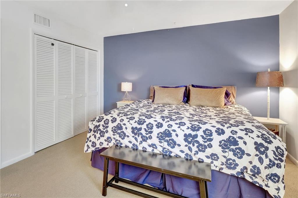 1919 Gulf Shore Boulevard North, Unit 201 Naples, FL 34102 - Photo 19 of 28 a bedroom with a bed and a curtain