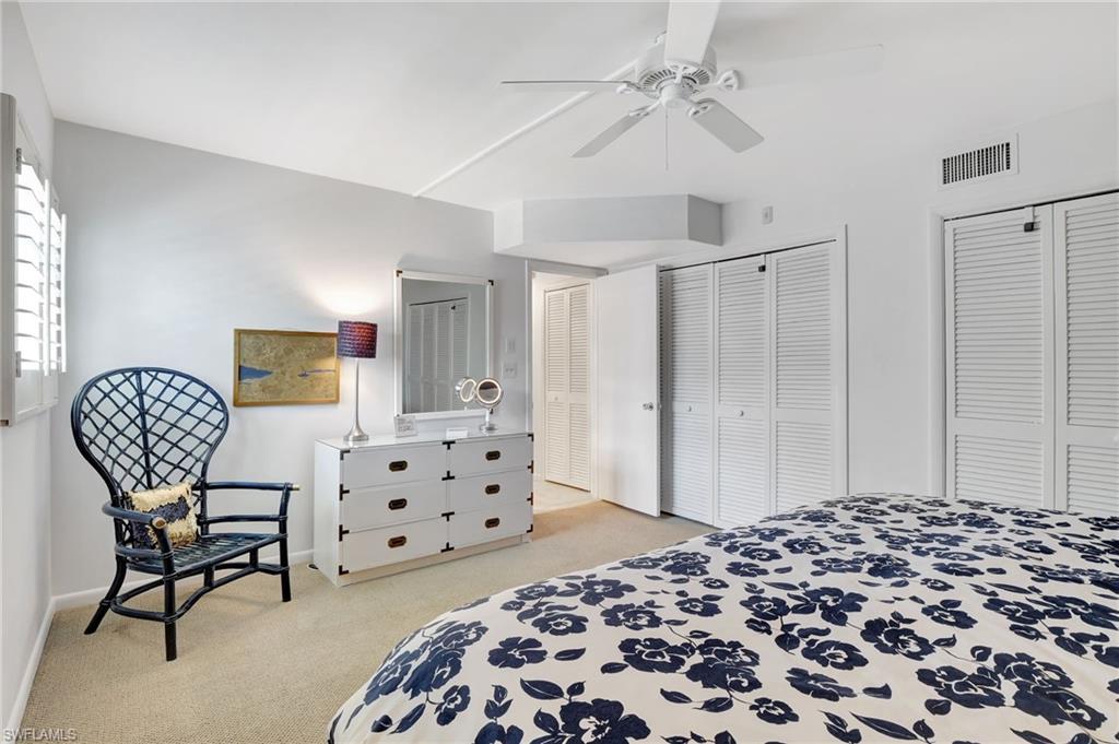 1919 Gulf Shore Boulevard North, Unit 201 Naples, FL 34102 - Photo 20 of 28 a bedroom with a bed and furniture