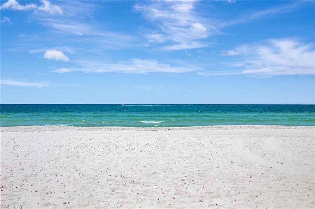 1919 Gulf Shore Boulevard North, Unit 201 Naples, FL 34102 - Photo 25 of 28 a view of a beach with a big yard