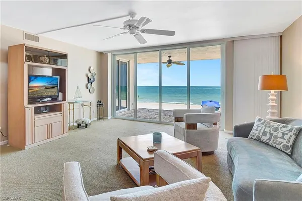 a living room with furniture and a large window