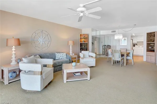 a view of a dining room with furniture and chandelier