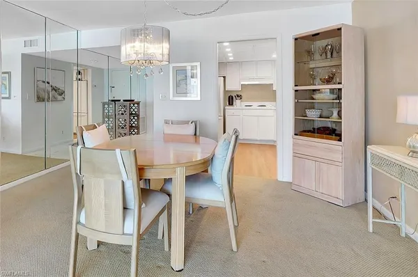 a kitchen with a sink a refrigerator a microwave and cabinets
