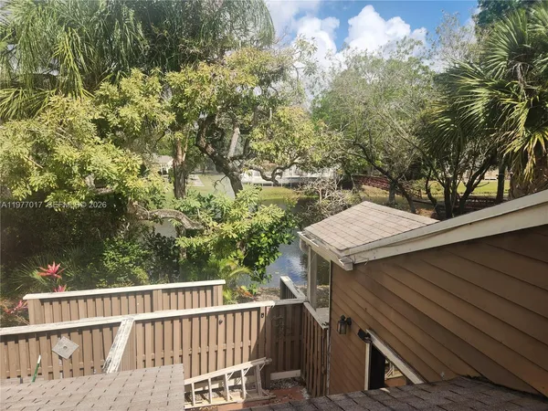 a view of a balcony with wooden fence and floor