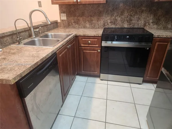 a kitchen with a sink stove and cabinets