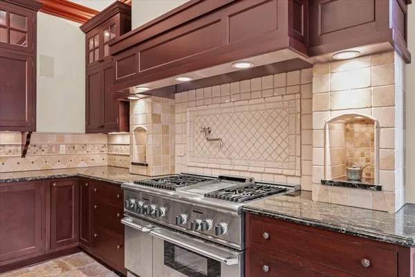 a view of a house with a small yard and potted plants