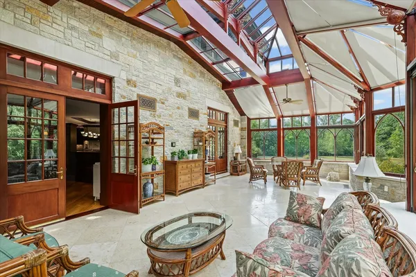 an aerial view of a house with a garden and lake view