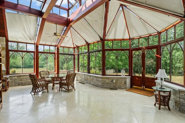 an aerial view of a house with a garden and lake view