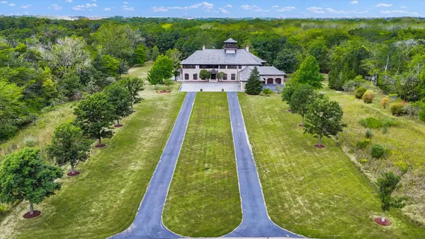 a view of a hallway with wooden floor and stairs