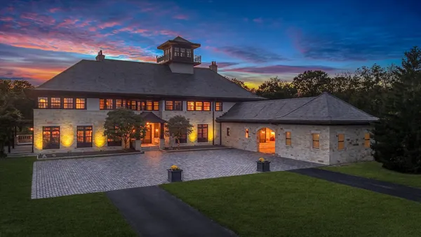a view of a hallway with wooden floor and a dining room