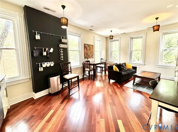 a living room with furniture and wooden floor