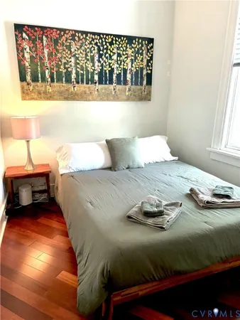 a bedroom with a bed and a window