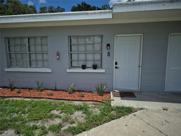 a couple of potted plants in front of door