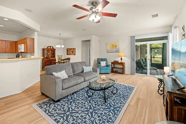 a living room with furniture and a wooden floor