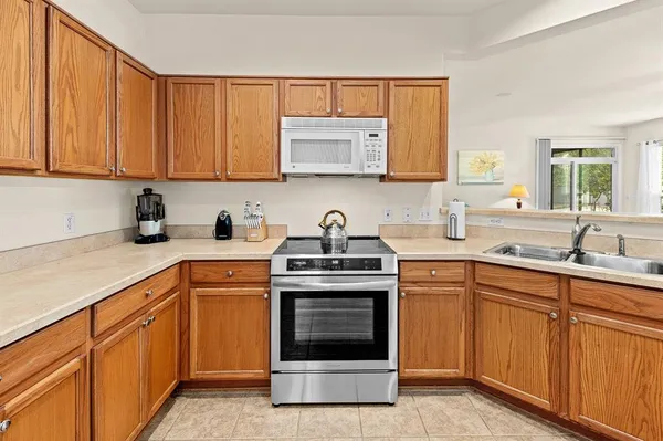 a kitchen with a sink cabinets and window