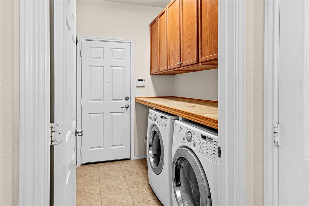 109 Providence Street Georgetown, TX 78633 - Photo 18 of 31 a view of storage and utility room with washer and dryer