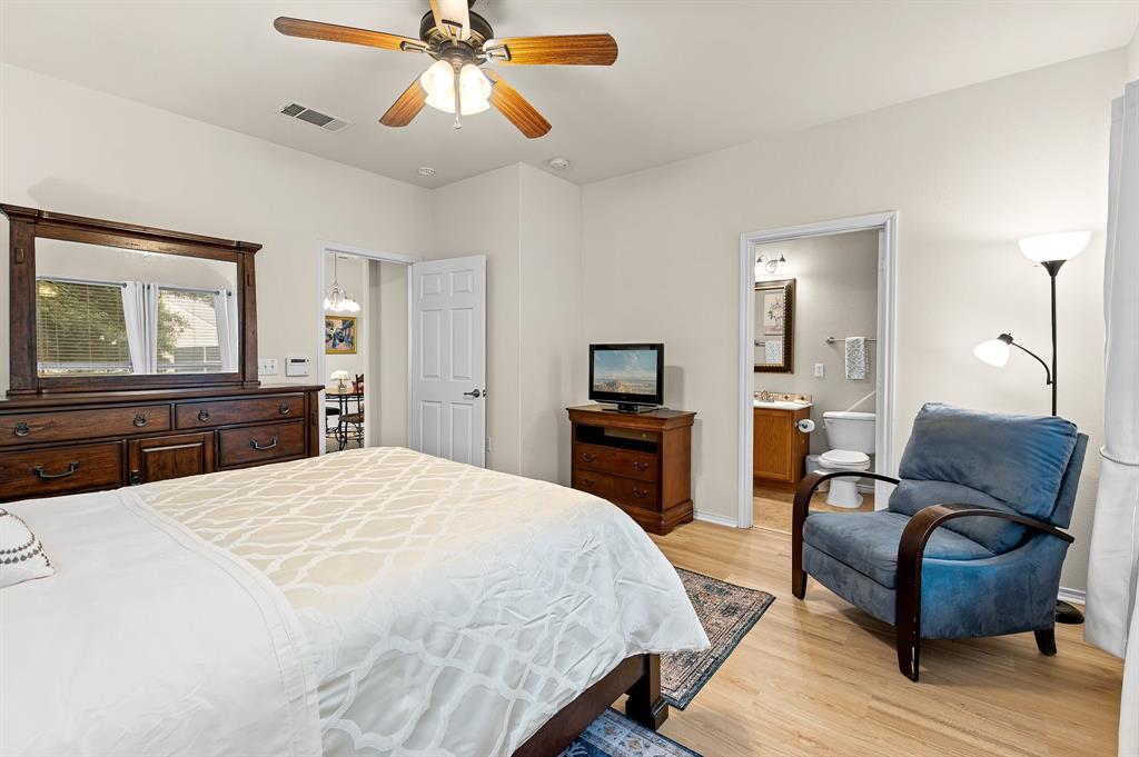 109 Providence Street Georgetown, TX 78633 - Photo 20 of 31 a bedroom with a bed and wooden floor