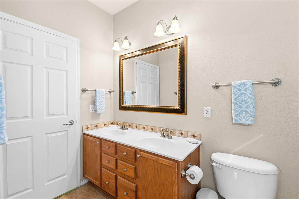109 Providence Street Georgetown, TX 78633 - Photo 21 of 31 a bathroom with a toilet sink and mirror