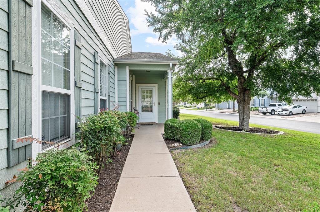 109 Providence Street Georgetown, TX 78633 - Photo 5 of 31 a view of a brick house with a yard and potted plants