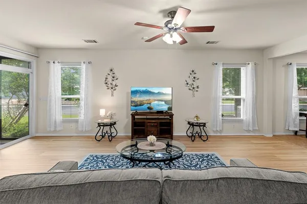 a living room with furniture and wooden floor