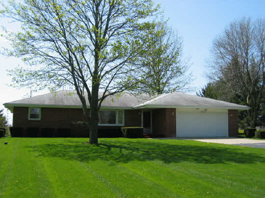 9668 Cunningham Road Winnebago, IL 61088 - Photo 1 of 6 a view of a house with a garden