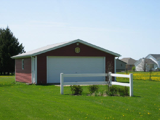 9668 Cunningham Road Winnebago, IL 61088 - Photo 2 of 6 a front view of a house with garden