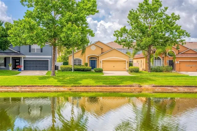 a view of a house with swimming pool and a yard