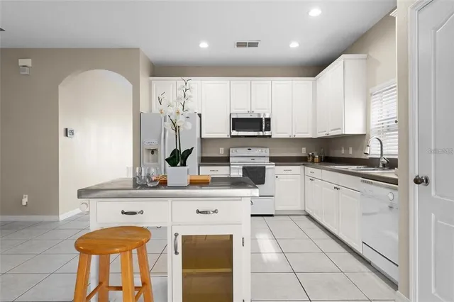 an empty room with a ceiling fan and window