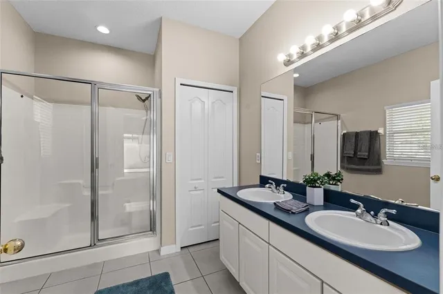 a bathroom with double vanity sinks and a mirror