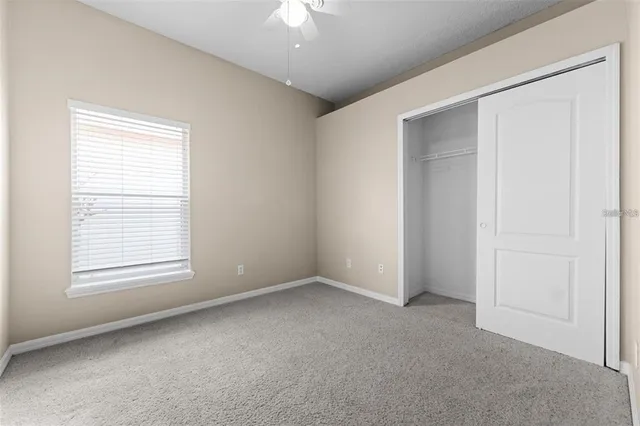 an empty room with a bathroom and mirror