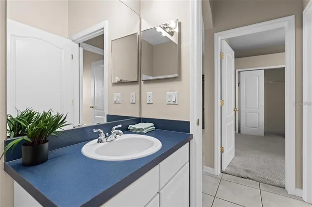 a bathroom with a toilet a sink a mirror a vanity and shower