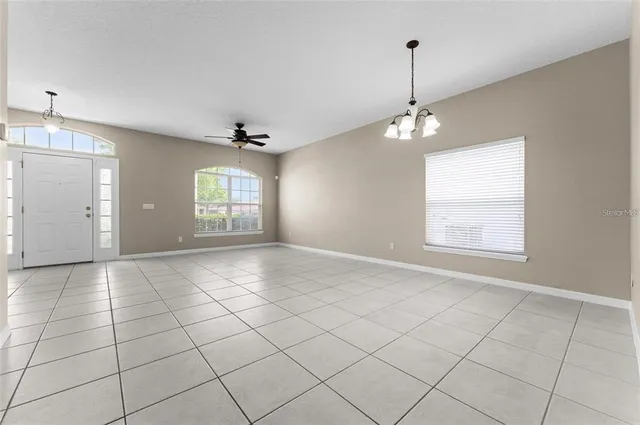 a view of an empty room and a window