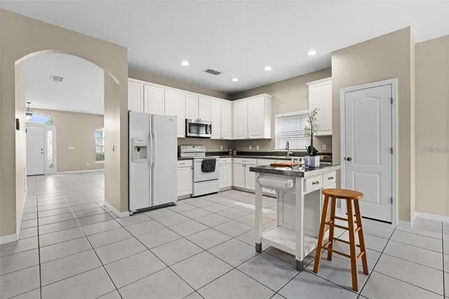 a kitchen with a sink cabinets and window