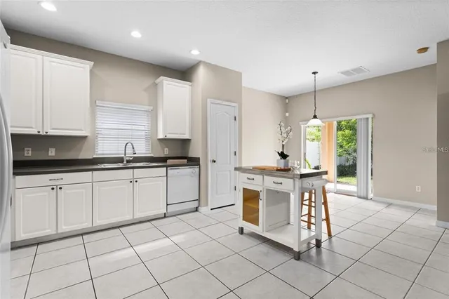 a kitchen with stainless steel appliances granite countertop a sink and a stove