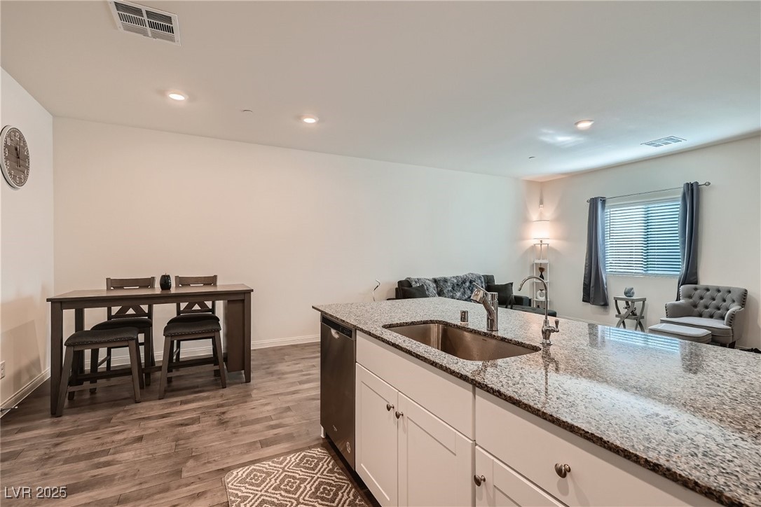 527 Clearsable Avenue Henderson, NV 89044 - Photo 11 of 11 Kitchen with white cabinetry, light stone countertops, open floor plan, dark wood-type flooring, and recessed lighting