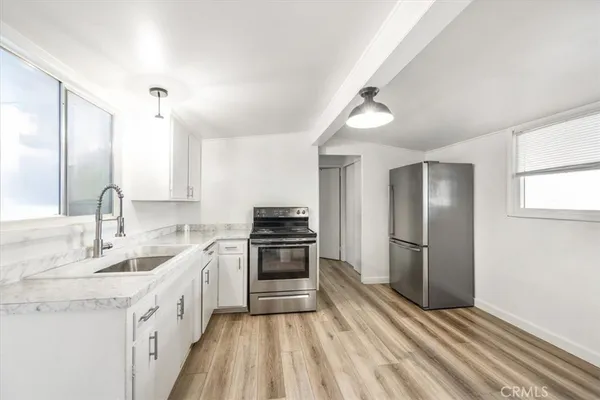 a kitchen with a sink appliances and cabinets