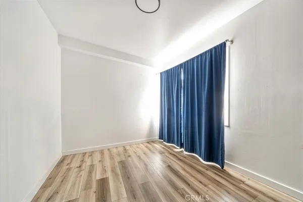 a view of a room with wooden floor and closet