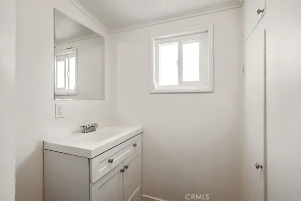 a bathroom with a sink vanity and a mirror