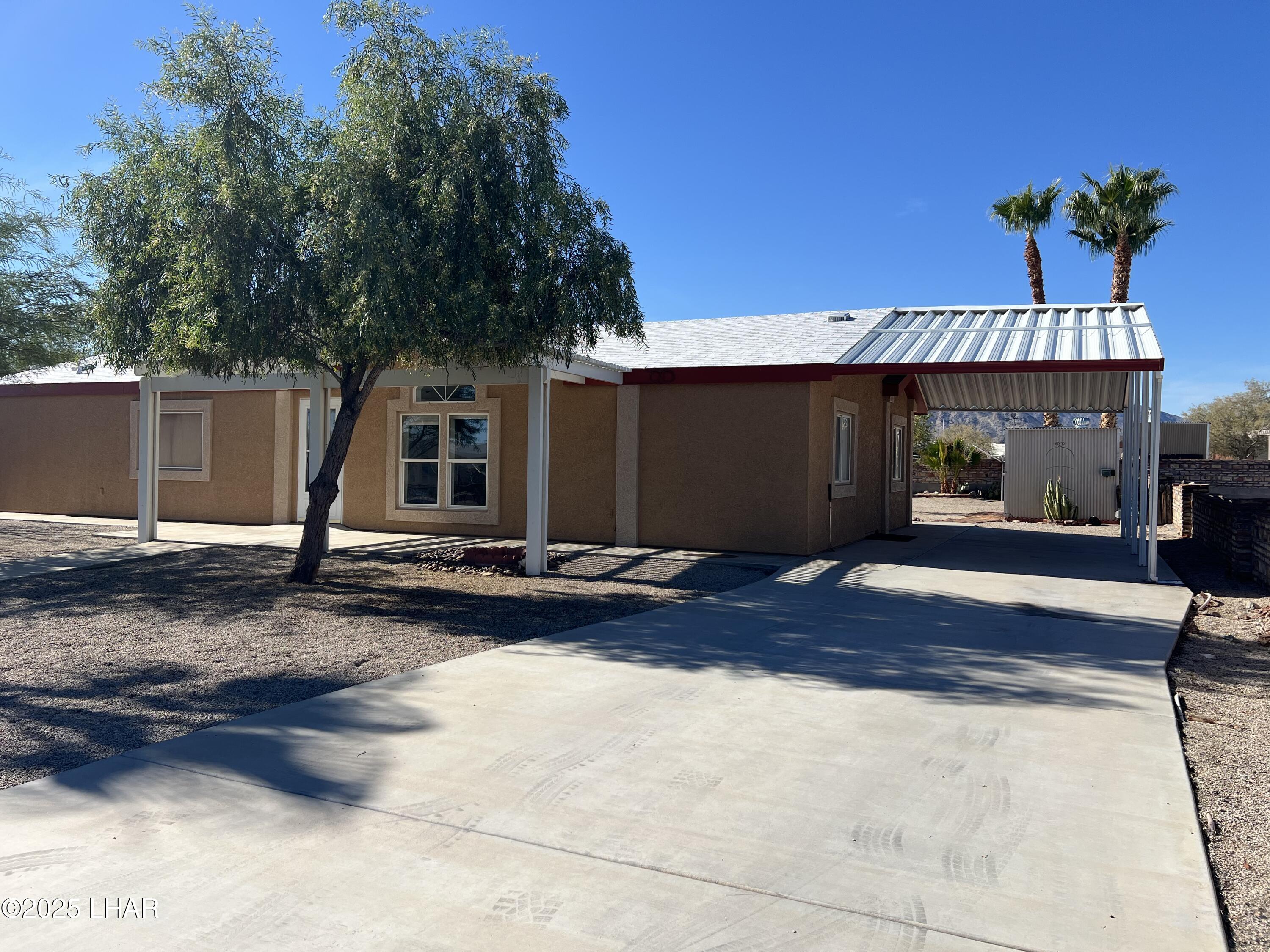 49688 Ruby Avenue Quartzsite, AZ 85346 - Photo 3 of 33 Palo verde in front and more palm trees in the back