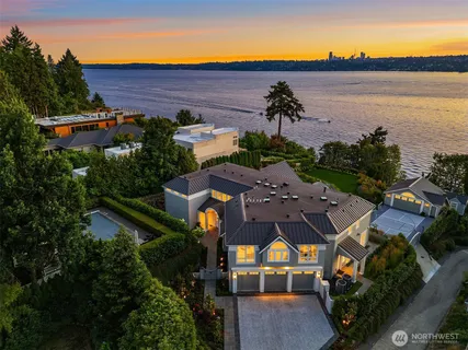 an aerial view of house with yard and ocean view