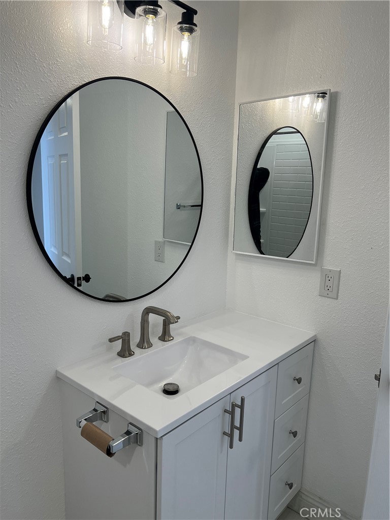 2255 Cahuiila Street, Unit 73 Colton, CA 92324 - Photo 10 of 12 a bathroom with a sink and a mirror
