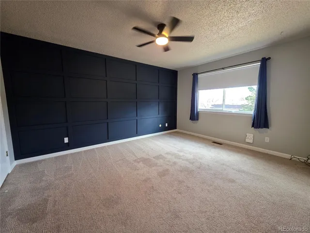 a view of empty room with ceiling fan