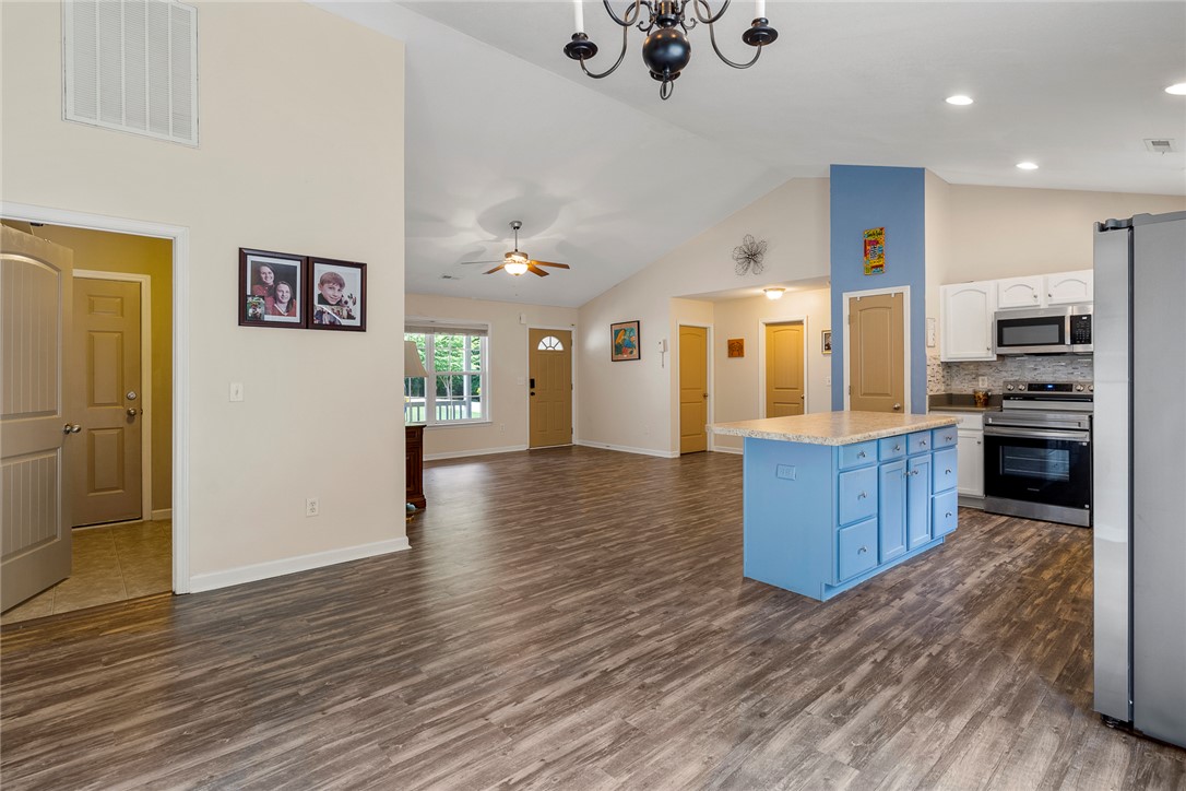 167 Mediterranean Avenue Anderson, SC 29621 - Photo 11 of 33 A well-lit, open-concept living space features vaulted ceilings and contemporary flooring.