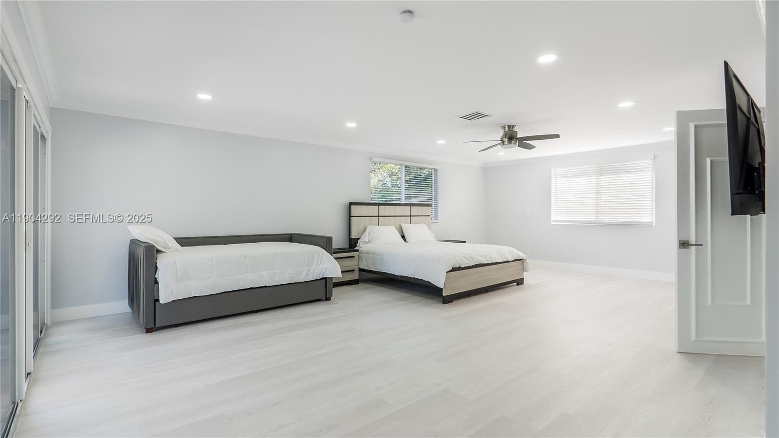 2445 Southeast 8th Street Pompano Beach, FL 33062 - Photo 19 of 42 a bedroom with a bed and a chandelier