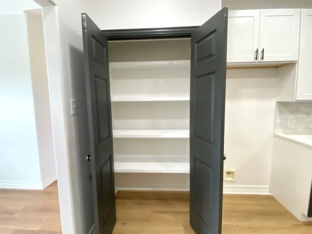 a view of walk in closet with empty racks